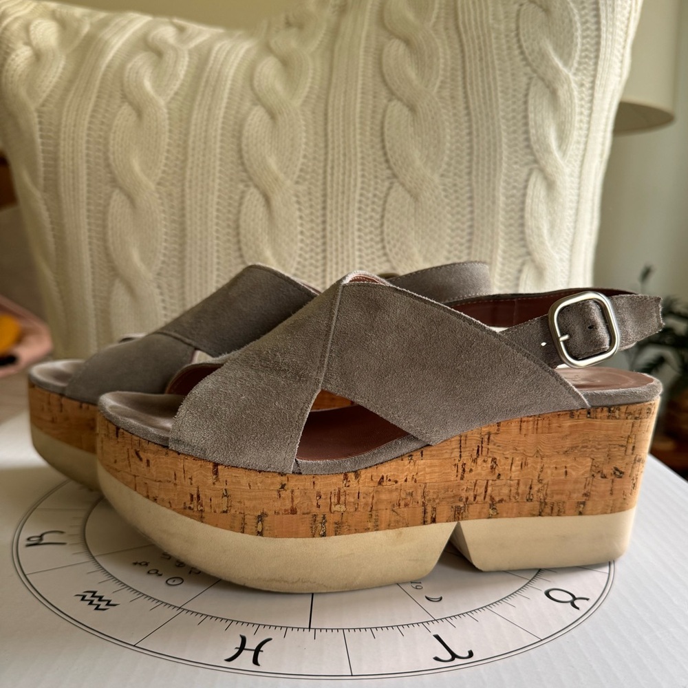 Homer’s platform cork and gray suede sandals. Signs of wear on the soles.
